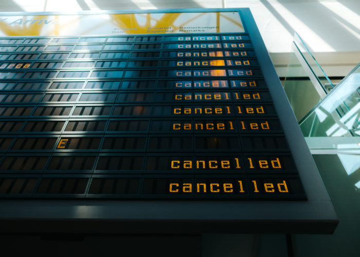 Departures and Arrivals board showing flight cancellations