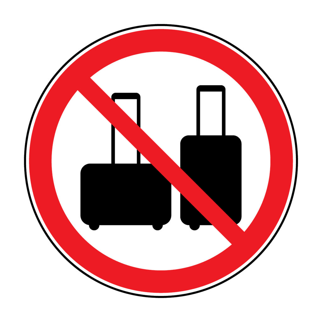 A graphic of two suitcases with a red "no" sign over them