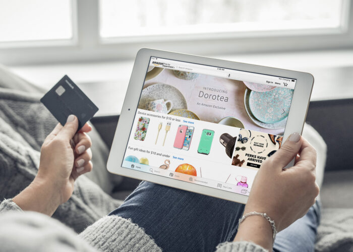 Woman using Amazon app on a brand new Apple iPad Pro Silver for online shopping