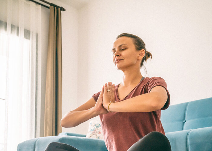 woman stretching meditating or yoga at home