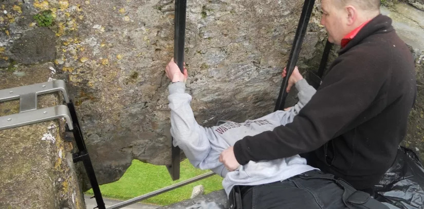 Tourist kissing the Blarney Stone at Blarney Castle